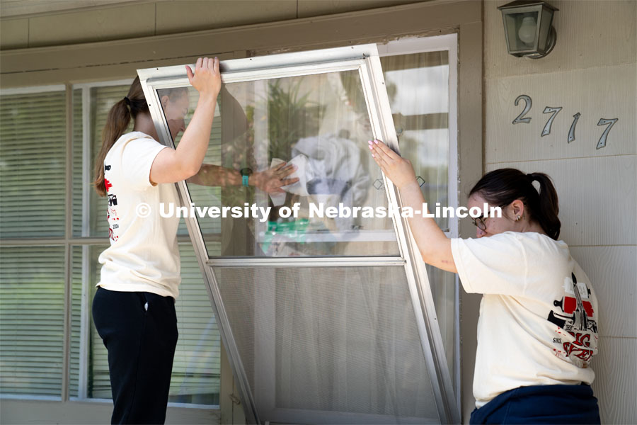Members of Tri Delta clean the exterior windows of a homeowner’s house during the Big Event. May 4, 2024. Photo by Kirk Rangel for University Communication.